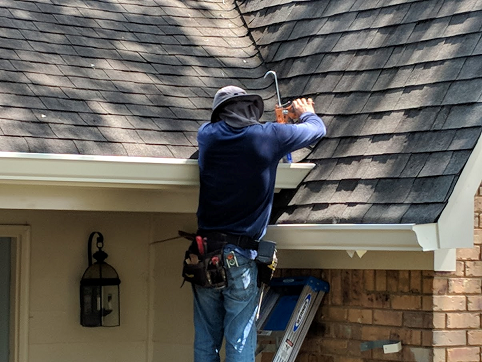 Picture of Doyle installing gutter on a home in Yulee, FL